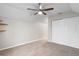 Bedroom with neutral walls and carpet, a ceiling fan, a closet, and shelving at 735 Deerfoot Rd, Deland, FL 32720