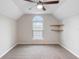 Bedroom with neutral walls and carpet, a ceiling fan, a large window, and shelving at 735 Deerfoot Rd, Deland, FL 32720