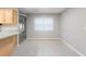 Bright dining area with tile floors, and a large window with modern neutral-toned walls at 735 Deerfoot Rd, Deland, FL 32720