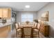 Elegant dining room with a large table set for a meal, complemented by stylish decor and natural light at 735 Deerfoot Rd, Deland, FL 32720