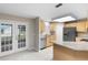 Spacious kitchen with light cabinets, stainless steel appliances, and access to the backyard at 735 Deerfoot Rd, Deland, FL 32720