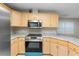 Modern kitchen featuring new stainless steel appliances, granite countertops, and light wood cabinetry at 735 Deerfoot Rd, Deland, FL 32720