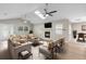 Staged living room with ample seating, fireplace and streaming natural light at 735 Deerfoot Rd, Deland, FL 32720