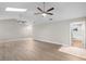 Open living room features vaulted ceilings, a skylight, two ceiling fans, and an ensuite bathroom at 735 Deerfoot Rd, Deland, FL 32720