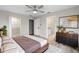 Light and airy main bedroom with a ceiling fan, wood floors, walk-in closet, and ensuite bathroom at 735 Deerfoot Rd, Deland, FL 32720