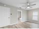 Bedroom with light-colored walls, ceiling fan, wood-look floors and view to bath at 735 Deerfoot Rd, Deland, FL 32720