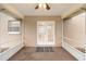 Covered patio with ceiling fan and french doors leading to the backyard at 735 Deerfoot Rd, Deland, FL 32720