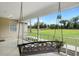 Inviting front porch with a hanging swing, perfect for relaxing and enjoying the scenic views at 735 Deerfoot Rd, Deland, FL 32720