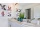 Bright bathroom with a double vanity, modern fixtures, a decorative mirror, and adorable puppy art at 7351 Capstone Dr, Groveland, FL 34736