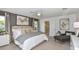 Bright, spacious main bedroom with a ceiling fan, neutral decor, a gray accent wall, and lots of natural light at 7351 Capstone Dr, Groveland, FL 34736