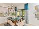 Dining area with modern decor, statement lighting, and access to an outdoor patio at 7351 Capstone Dr, Groveland, FL 34736