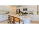 Open kitchen with quartz island, stainless steel appliances, modern cabinetry, and lots of counter space at 7351 Capstone Dr, Groveland, FL 34736
