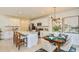 Stylish open-concept kitchen with island, stainless steel appliances, and adjacent dining area at 7351 Capstone Dr, Groveland, FL 34736