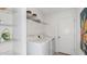 Practical laundry room with modern appliances, shelving, a storage space, and a clean, white interior at 7351 Capstone Dr, Groveland, FL 34736