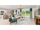 Bright and airy living room with modern decor, large windows, and an open layout to kitchen at 7351 Capstone Dr, Groveland, FL 34736