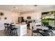 Open-concept kitchen with white cabinetry, stainless steel appliances, and an island with bar seating at 7355 Capstone Dr, Groveland, FL 34736