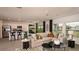 Open-concept living space with a modern kitchen, dining area, and comfortable living room at 7355 Capstone Dr, Groveland, FL 34736