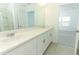 Bathroom features a double sink vanity with white countertops and tiled floors at 7367 Capstone Dr, Groveland, FL 34736