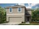 Charming two-story home featuring a two-car garage and a beautifully landscaped front yard at 7367 Capstone Dr, Groveland, FL 34736