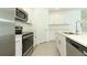 Modern kitchen with stainless steel appliances, bright countertops, and sleek cabinetry at 7367 Capstone Dr, Groveland, FL 34736