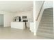 Open kitchen with stainless steel appliances, an island, and a staircase to the right at 7367 Capstone Dr, Groveland, FL 34736