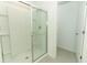 Bathroom showcasing a glass-enclosed shower with tiled walls and floor at 7367 Capstone Dr, Groveland, FL 34736
