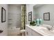 Bright bathroom featuring a shower and tub combination, a vanity with ample counter space, and neutral tones at 7384 Capstone Dr, Groveland, FL 34736