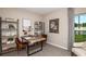Well-lit bedroom with a neutral color scheme, a modern desk, shelving, and a view of the outdoors at 7384 Capstone Dr, Groveland, FL 34736