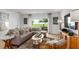 Cozy living room with natural light, modern sofa, stylish decor, and view of the outdoor space at 7384 Capstone Dr, Groveland, FL 34736