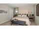 Serene main bedroom with a large bed, neutral tones, soft lighting, and classic decor at 7384 Capstone Dr, Groveland, FL 34736