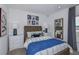 Charming bedroom featuring a wooden bed frame, stylish décor, and natural light from the window at 7392 Capstone Dr, Groveland, FL 34736