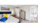 Neutral bedroom with a blue headboard, grey dresser, and a comfortable striped bed at 7404 Capstone Dr, Groveland, FL 34736