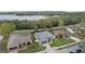 Aerial shot featuring a house with mature trees and proximity to a lake at 839 High Pointe Cir, Minneola, FL 34715