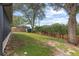 Well-maintained backyard featuring a wood fence and ample green space at 839 High Pointe Cir, Minneola, FL 34715
