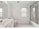 Well-lit bathroom featuring a shower with glass door, white tiled floors, and a large vanity at 839 High Pointe Cir, Minneola, FL 34715