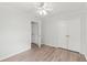 Bedroom featuring hardwood floors, ceiling fan, closet, and a bright window overlooking the yard at 839 High Pointe Cir, Minneola, FL 34715