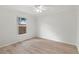 Bright bedroom with a ceiling fan, hardwood floors, and a window overlooking the fenced yard at 839 High Pointe Cir, Minneola, FL 34715
