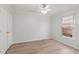 Comfortable bedroom with a ceiling fan, wood flooring, and a bright window at 839 High Pointe Cir, Minneola, FL 34715
