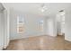 A neutral colored bedroom offers two windows, neutral tile floors, and access to a walk-in closet at 839 High Pointe Cir, Minneola, FL 34715