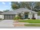 Charming one-story home with well-manicured lawn and a two-car garage at 839 High Pointe Cir, Minneola, FL 34715