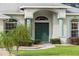 Close up of the front door with decorative columns and landscaping at 839 High Pointe Cir, Minneola, FL 34715