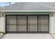 The home's two car garage has an oversized screened garage door at 839 High Pointe Cir, Minneola, FL 34715