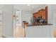 A kitchen with wooden cabinets, stainless steel appliances, and granite countertops is seen from a distance at 839 High Pointe Cir, Minneola, FL 34715