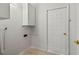 Practical laundry room with storage cabinets and door to the backyard at 839 High Pointe Cir, Minneola, FL 34715