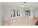 This living room features white paint, tile floors, white ceiling with a ceiling fan and exterior access at 839 High Pointe Cir, Minneola, FL 34715