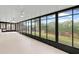 Bright sunroom with tiled floor and large windows overlooking the backyard at 839 High Pointe Cir, Minneola, FL 34715