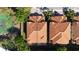 Birds-eye view of two homes with clay tile roofs in a residential neighborhood, divided by a property line at 8950 Della Scala Cir, Orlando, FL 32836