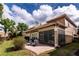 Spacious backyard with a screened-in patio, brick pavers, and lush landscaping, perfect for outdoor enjoyment at 8950 Della Scala Cir, Orlando, FL 32836