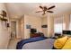 Comfortable bedroom featuring a ceiling fan, a dresser with a TV, and access to an ensuite bathroom at 8950 Della Scala Cir, Orlando, FL 32836