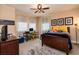 Nicely decorated bedroom with a ceiling fan, a cozy bed, and a dedicated desk area for work or study at 8950 Della Scala Cir, Orlando, FL 32836
